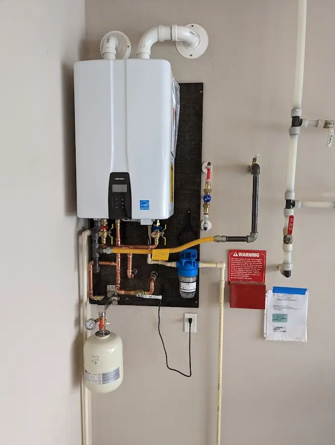 Professional plumber installing copper piping in a Paloma Creek South home